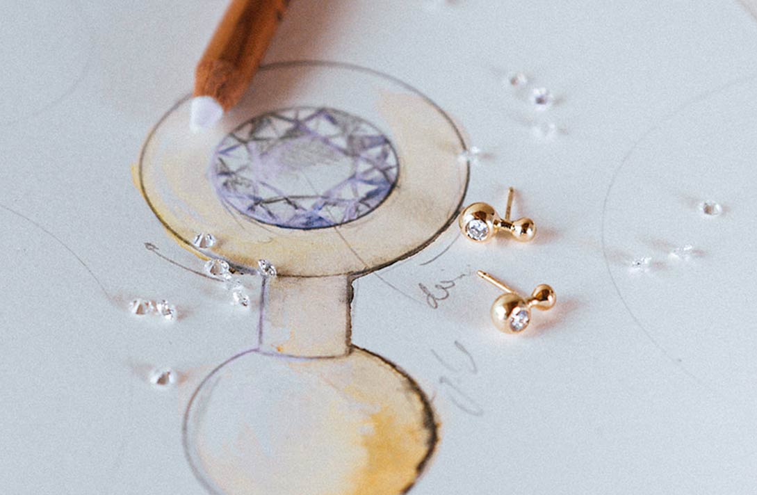 Labor Diamanten und Ohrringe liegen auf Zeichnung der Ohrringe mit Labor Diamant
