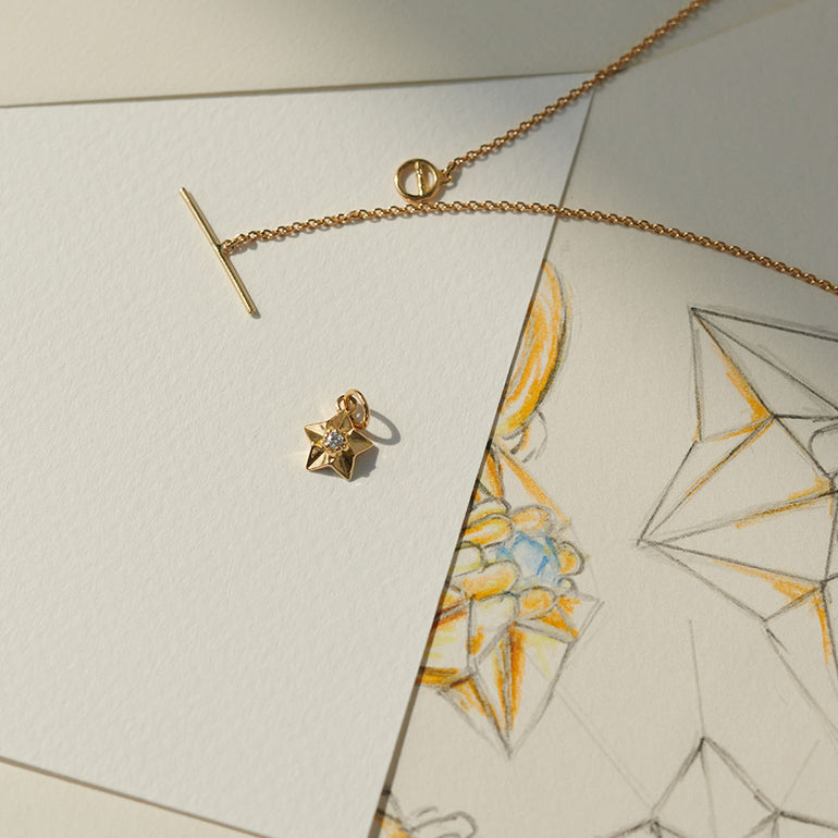 Stern Anhänger und Gold Kette auf Skizze und Design des Sterns