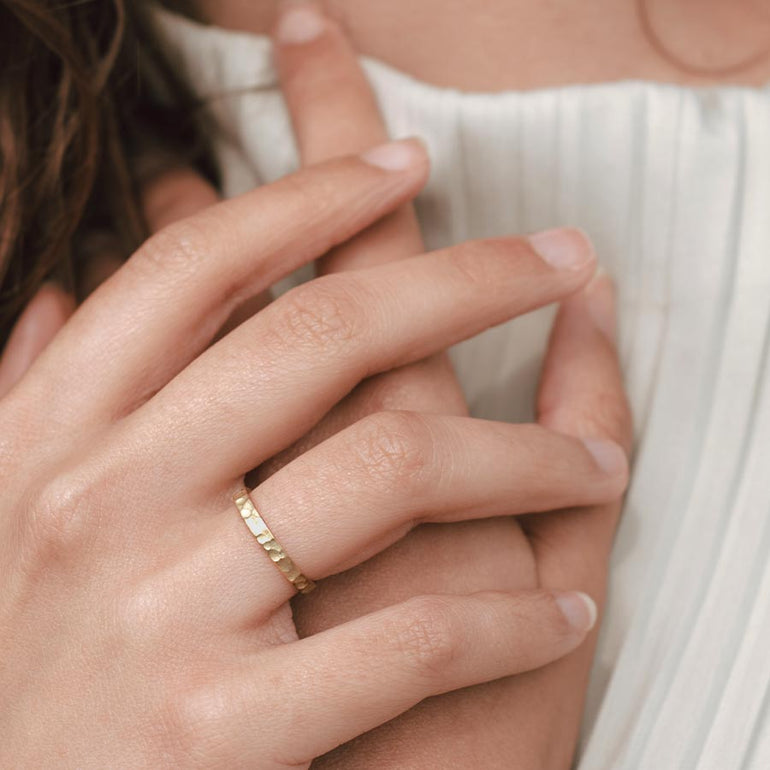 gehämmerter Ehering an Frauen Hand