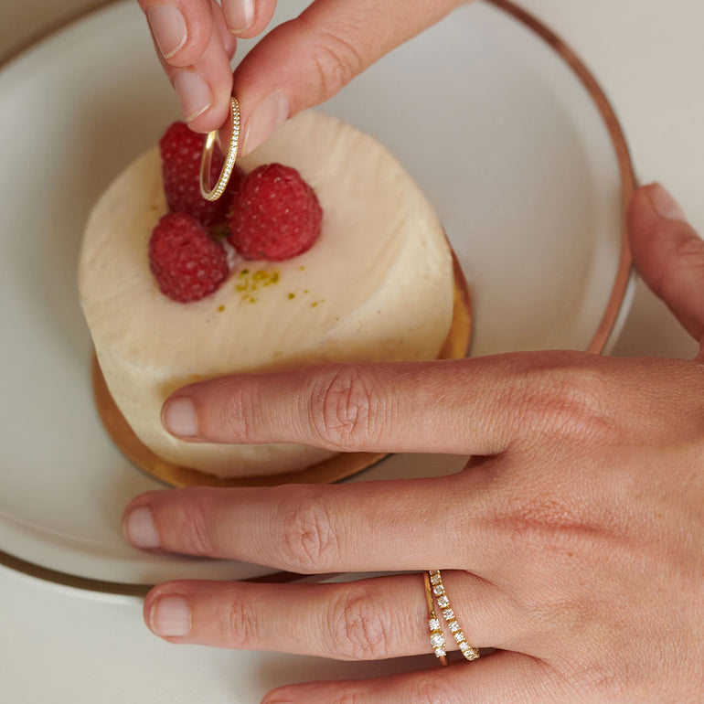 Stilvolle Ewigkeitsringe aus recyceltem Gold mit Labordiamanten besetzt von Maren Jewellery werden zusammen mit einem Himbeertörtchen präsentiert