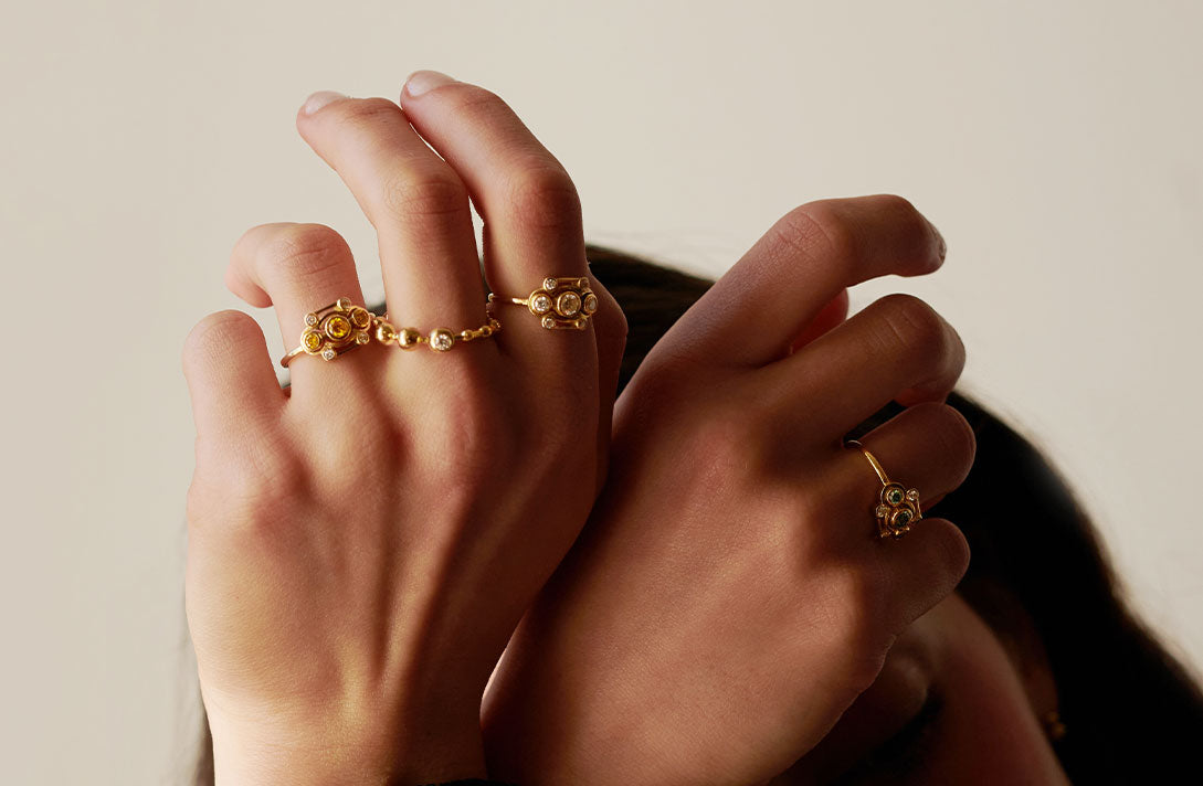 Women’s hands with distinctive rings by Maren Jewellery made from recycled gold and lab-grown diamonds