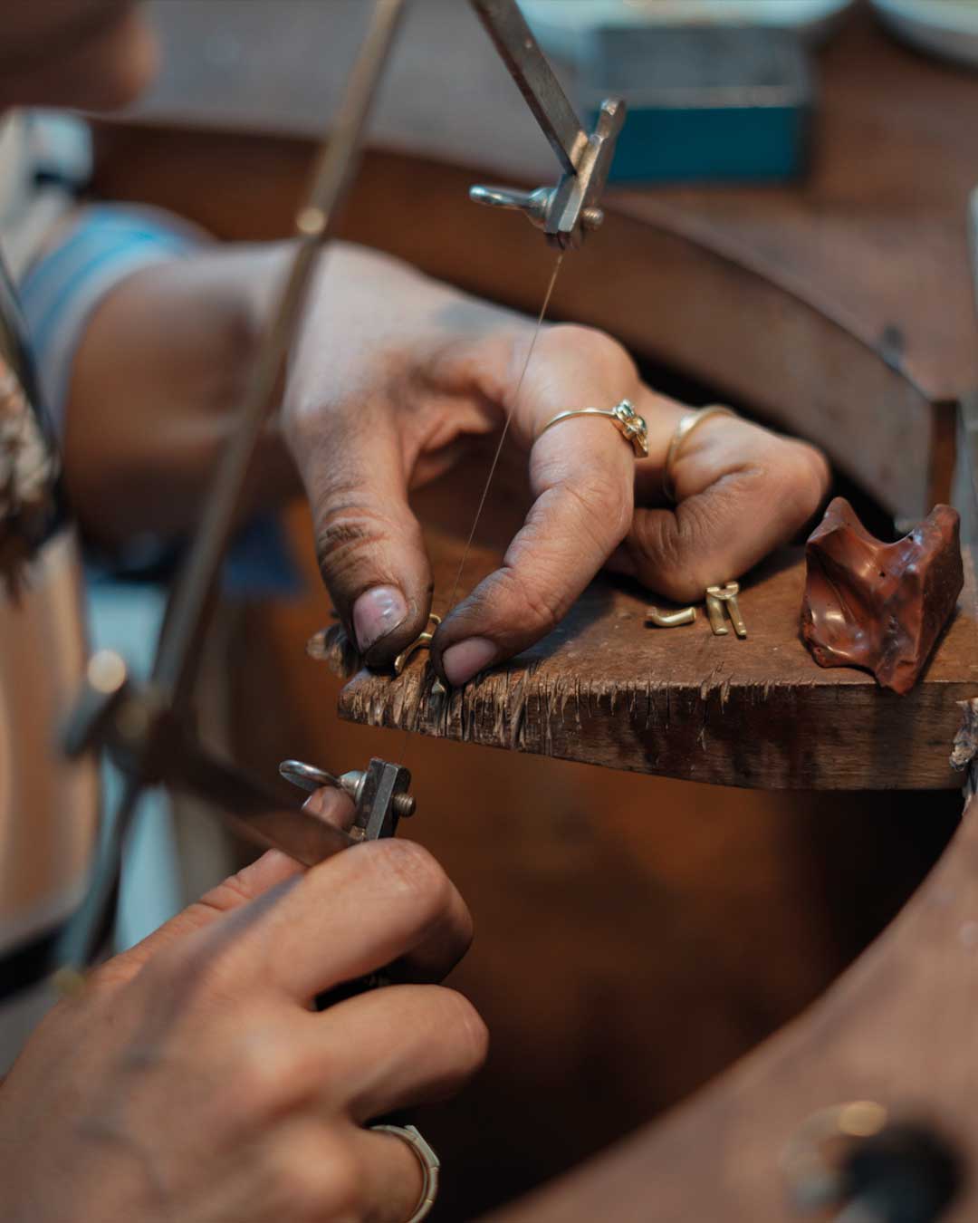 Detailaufnahme zeigt filigranes Zurechtsägen von nachhaltigen Schmuckrohlingen am Goldschmiedetisch von Maren Jewellery