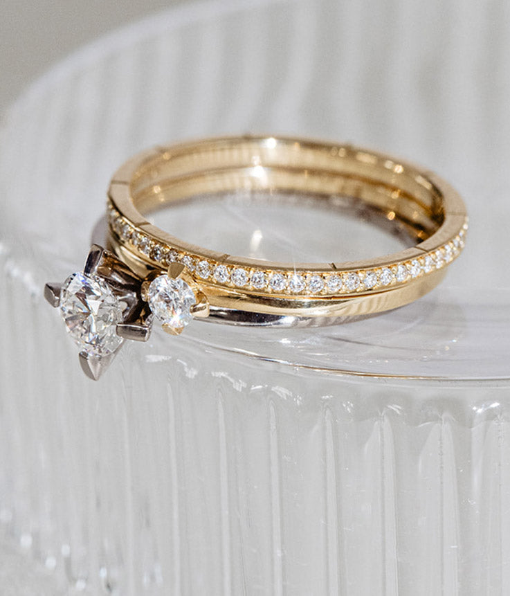 Detail of the solitaire ring and eternity ring by Maren Jewellery in recycled gold and lab-grown diamonds