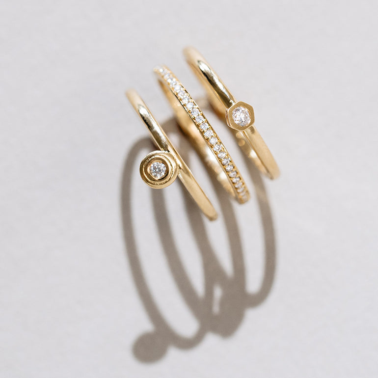 Handgefertigte Designer Memoire- und Solitaire Ringe aus recyceltem Gold und mit Labordiamanten besetzt von Maren Jewellery auf weißem Untergrund mit Beleuchtung von der Seite